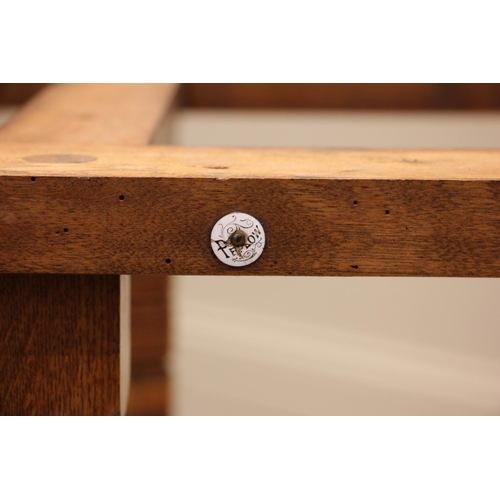 841 - An Edwardian oak octagonal library table, by Collinson and Lock, London, the moulded octagonal top u... 