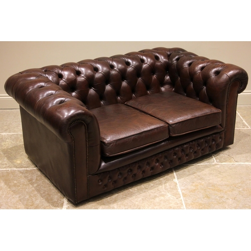 845 - A nut brown leather two seater Chesterfield sofa, late 20th century, of typical deep set form with b... 