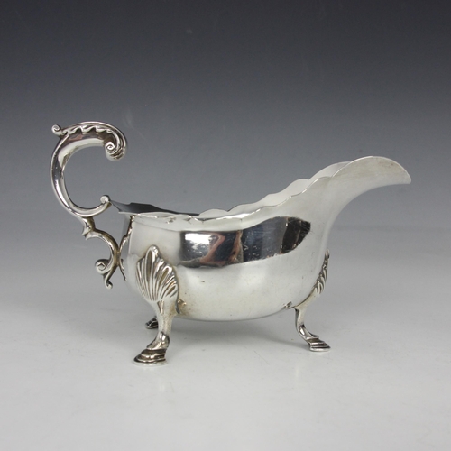 13 - A Victorian silver sauce boat, Charles Stuart Harris, London 1898, the acanthus capped flying handle... 