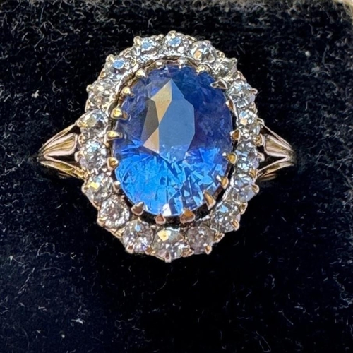 348 - An Edwardian certified sapphire and diamond cluster ring, the oval cut sapphire within a surround of... 