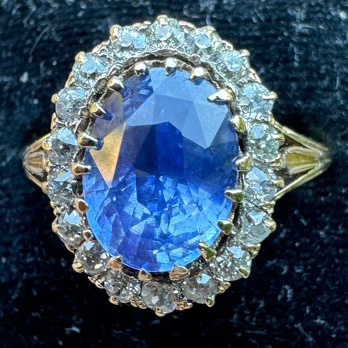 348 - An Edwardian certified sapphire and diamond cluster ring, the oval cut sapphire within a surround of... 