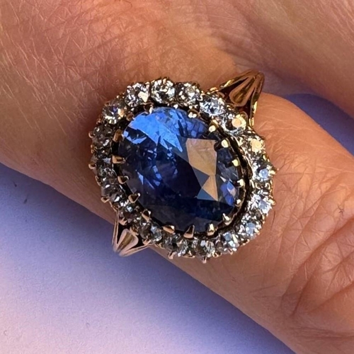 348 - An Edwardian certified sapphire and diamond cluster ring, the oval cut sapphire within a surround of... 