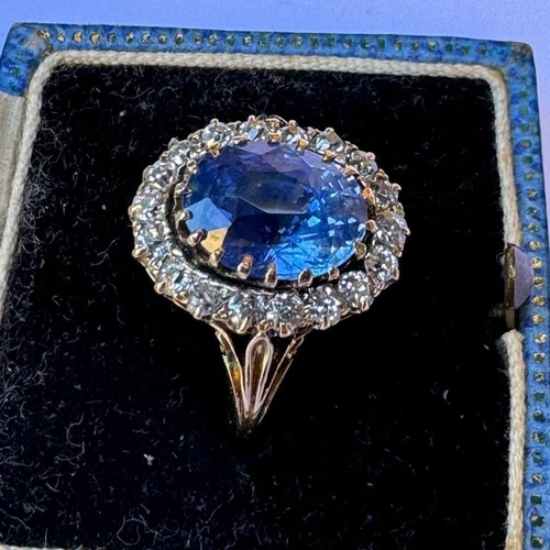 348 - An Edwardian certified sapphire and diamond cluster ring, the oval cut sapphire within a surround of... 