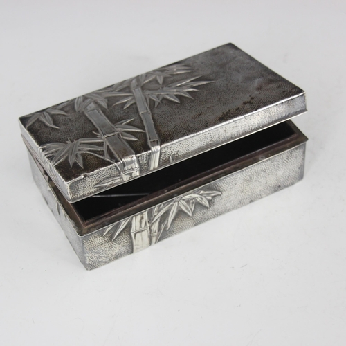 50 - A 20th century Chinese white metal cigarette box, the rectangular box with all over bamboo decoratio... 