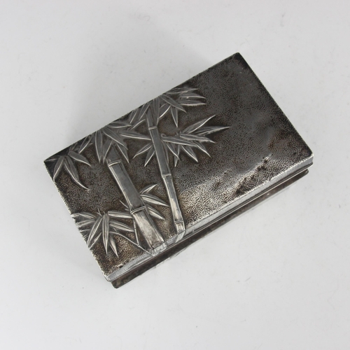 50 - A 20th century Chinese white metal cigarette box, the rectangular box with all over bamboo decoratio... 