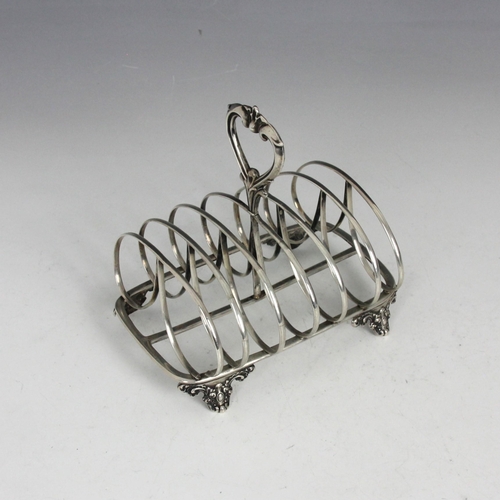 56 - A Victorian silver toast rack, John Evans II, London 1844, the cast openwork stylised handle above l... 