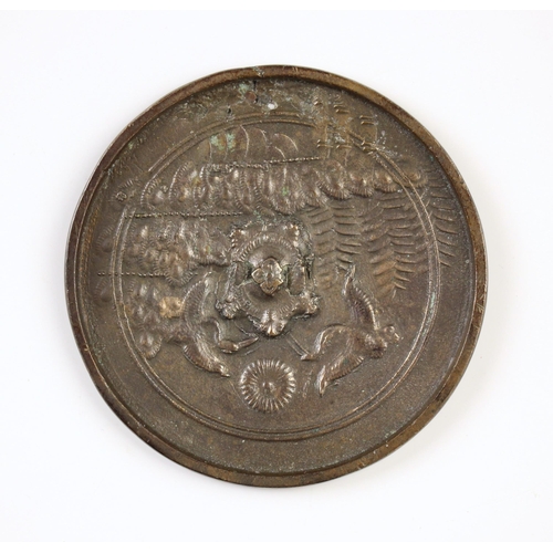 586A - A Japanese bronze disc mirror, 18/19th century, of circular form with crane decoration to one side, ... 