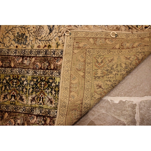 611 - A silkwork rug, late 19th/early 20th century, in ivory, green and brown colorways, the central field... 