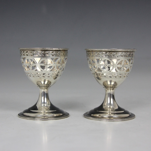 64 - A pair of George III silver egg cups, Hester Bateman, London 1787, of typical form, the beaded rim a... 