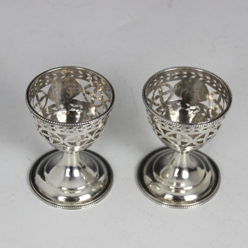 64 - A pair of George III silver egg cups, Hester Bateman, London 1787, of typical form, the beaded rim a... 