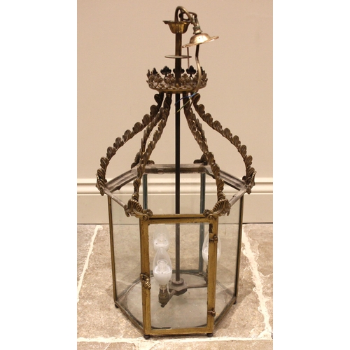 656 - A brass hanging hall lantern, late 19th/early 20th century, of hexagonal form, the circular boss wit... 