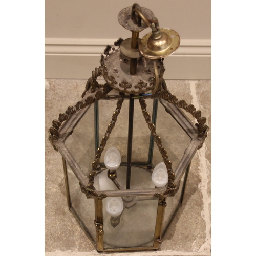 656 - A brass hanging hall lantern, late 19th/early 20th century, of hexagonal form, the circular boss wit... 