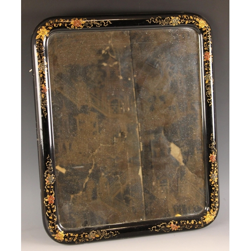 662 - A Japanned wall mirror, early to mid 20th century, the rounded black lacquer frame applied with gilt... 