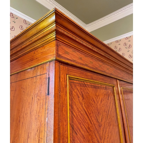 821 - An Edwardian satinwood linen press in the manner of Maple & Co, London, the moulded and simulated de... 