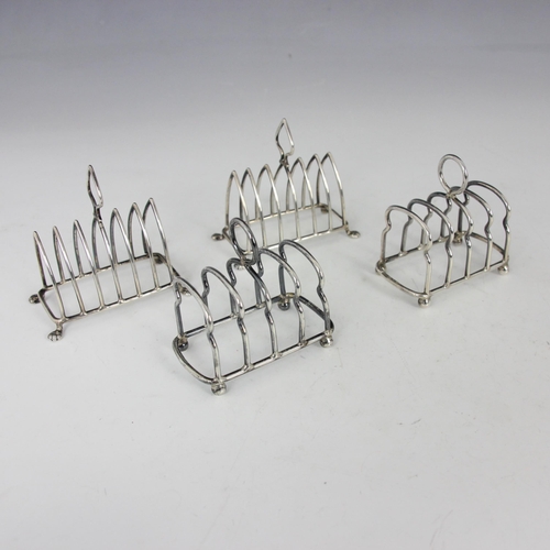 51 - A pair of Edwardian silver toast racks, Joseph Jennens and Co, Birmingham 1909, of arched form upon ... 