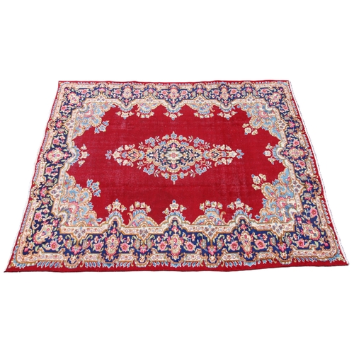 674 - A rich red ground Persian Kashmar carpet, the central floral medallion upon a vibrant red ground, em... 