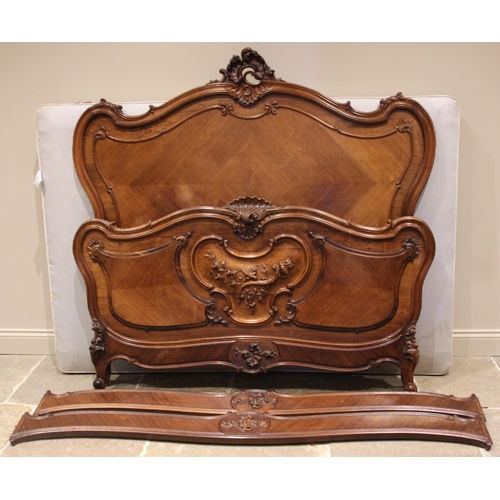 817 - A French Louis XV style kingwood and rosewood bed, late 19th/early 20th century, the serpentine head... 