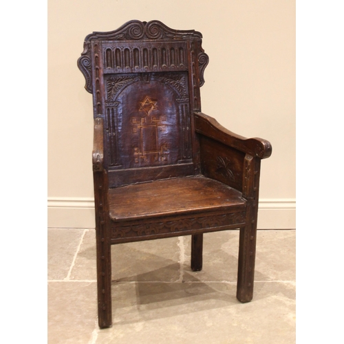 720 - An 18th century and later oak Wainscot chair, the carved scrolled pediment over a nulled frieze and ... 