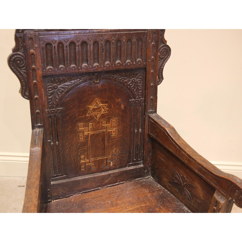 720 - An 18th century and later oak Wainscot chair, the carved scrolled pediment over a nulled frieze and ... 