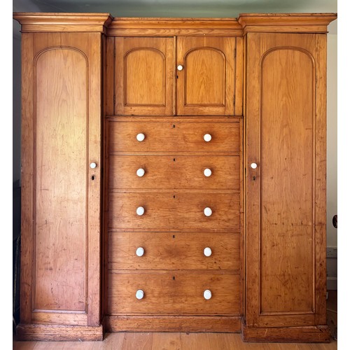 807 - A Victorian pine inverted breakfront compactum wardrobe, the moulded cornice over a pair of recessed... 