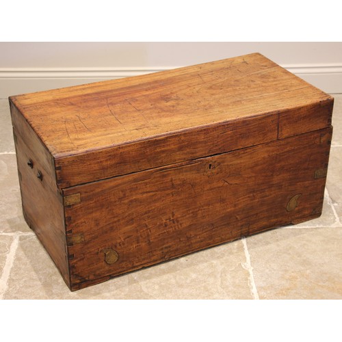 765 - A teak campaign chest, 19th century, applied with brass corner brackets, opening to a fitted candle ... 