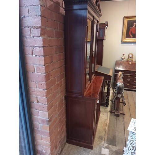 762 - An Edwardian Sheraton revival mahogany library bookcase, the architectural pediment inlaid with sati... 