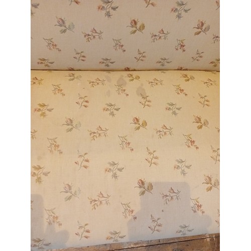 727 - A George III oak and upholstered sofa, later re-covered in cream coloured floral fabric, the straigh... 