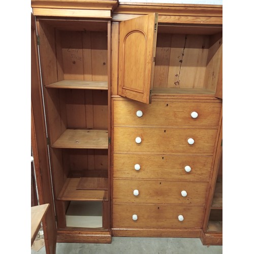 807 - A Victorian pine inverted breakfront compactum wardrobe, the moulded cornice over a pair of recessed... 