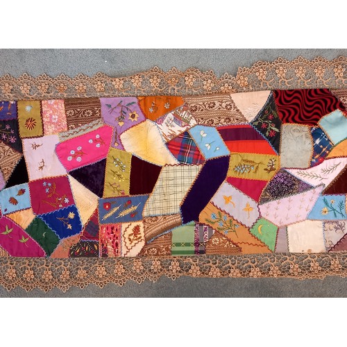 607 - A Victorian patchwork panel, late 19th century, the random shaped pieces with cross-stitch borders a... 