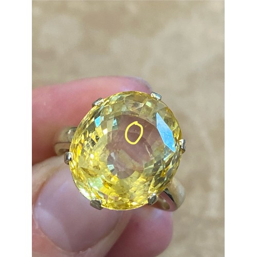 257 - A bespoke untested yellow sapphire cocktail ring, possibly Sri Lankan, the fancy oval cut stone with... 