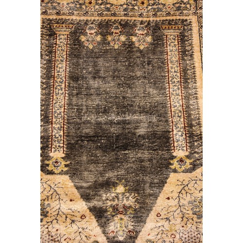 611 - A silkwork rug, late 19th/early 20th century, in ivory, green and brown colorways, the central field... 