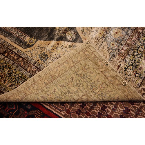 611 - A silkwork rug, late 19th/early 20th century, in ivory, green and brown colorways, the central field... 