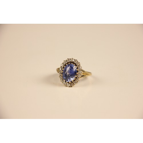 348 - An Edwardian certified sapphire and diamond cluster ring, the oval cut sapphire within a surround of... 