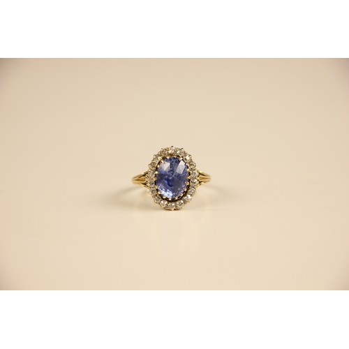 348 - An Edwardian certified sapphire and diamond cluster ring, the oval cut sapphire within a surround of... 