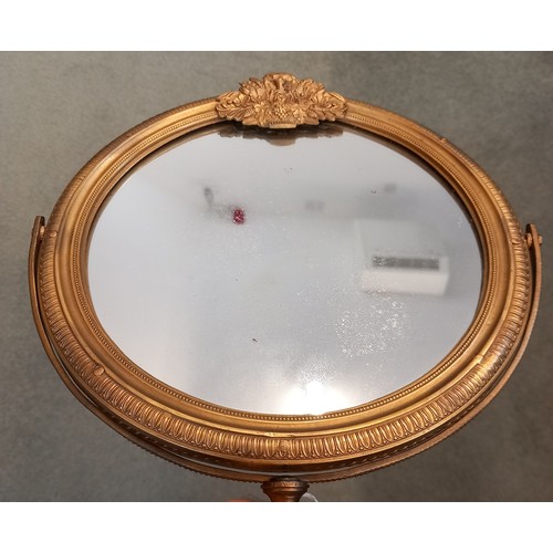 665 - An Empire ormolu shaving or dressing table mirror, early 19th century, the circular frame surmounted... 