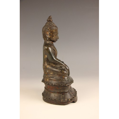 602 - A South-East Asian bronze model of a seated buddha, Nepal, 18th century, seated in dhyanasana with h... 