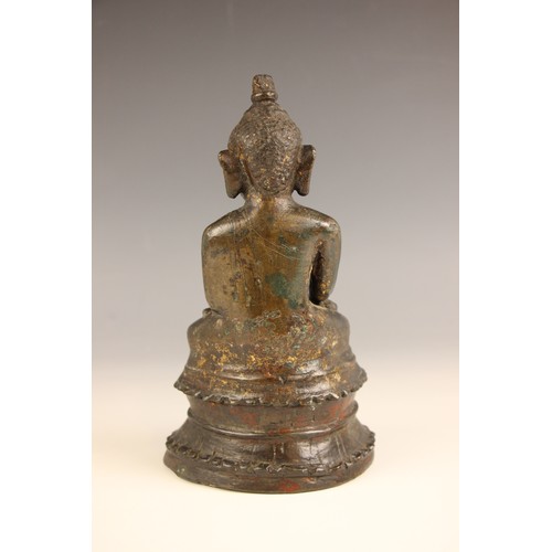 602 - A South-East Asian bronze model of a seated buddha, Nepal, 18th century, seated in dhyanasana with h... 