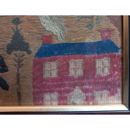 612 - A wool embroidered needlework picture or sampler, 19th century, depicting a village scene with birds... 