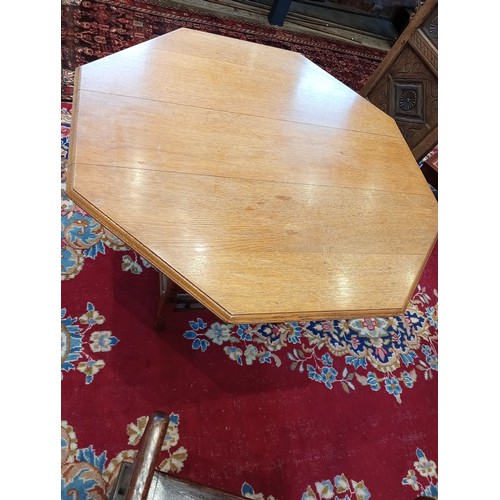 841 - An Edwardian oak octagonal library table, by Collinson and Lock, London, the moulded octagonal top u... 