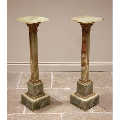 1010 - A pair of green onyx and gilt metal mounted pedestals, mid 20th century, the tapering square section... 