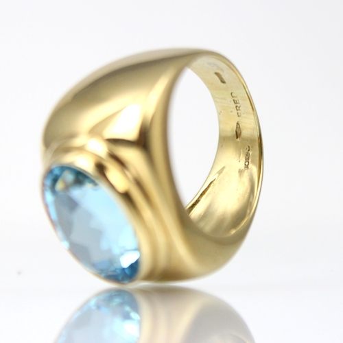 185 - A 'Fred' Paris 18ct yellow gold untested blue topaz dress ring, the oval mixed cut blue stone within... 