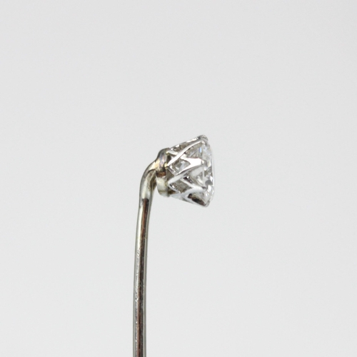 197 - An early 20th century diamond stick pin, the central old cut diamond in white metal claw setting edg... 