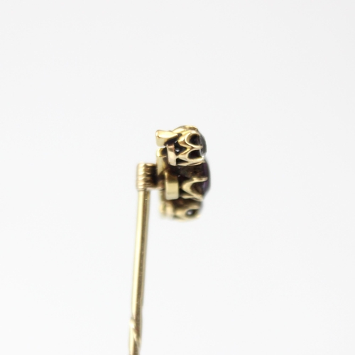 200 - A 19th century diamond stick pin, the central pink stone with old cut diamond to each side, within y... 