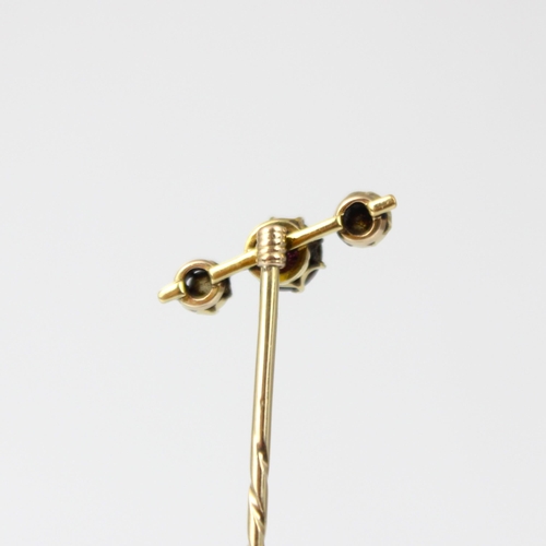 200 - A 19th century diamond stick pin, the central pink stone with old cut diamond to each side, within y... 