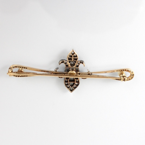 235 - A late 19th century diamond brooch, the central fleur de lis designed motif set with rose cut diamon... 