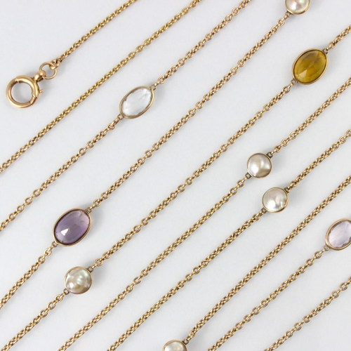 273 - A 20th century spectacle set blister pearl and gemstone set long guard chain, the trace link yellow ... 