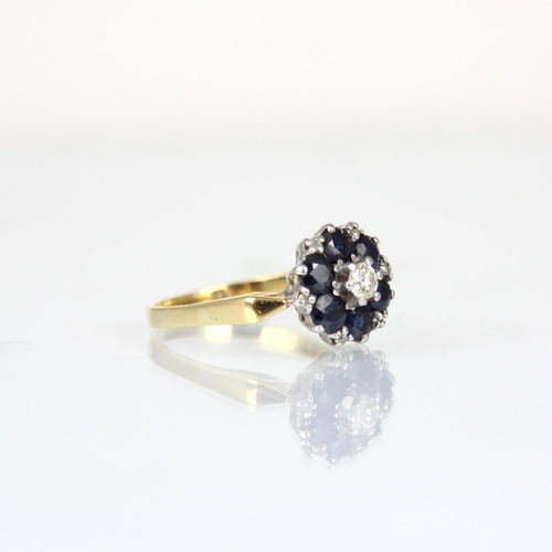 298 - An Edwardian style sapphire and diamond cluster ring, the central round cut diamond within surround ... 