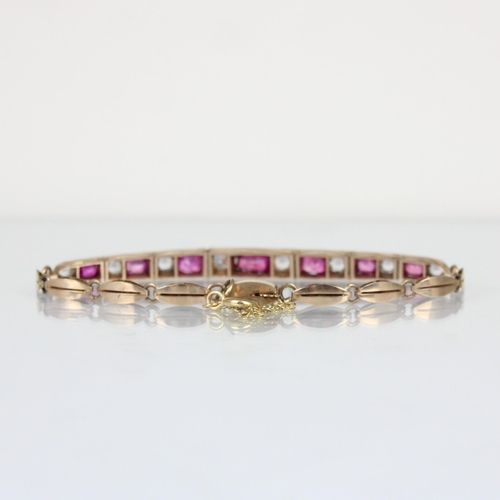 301 - A 20th century untested ruby and white sapphire bracelet, the seven mixed cut untested rubies within... 