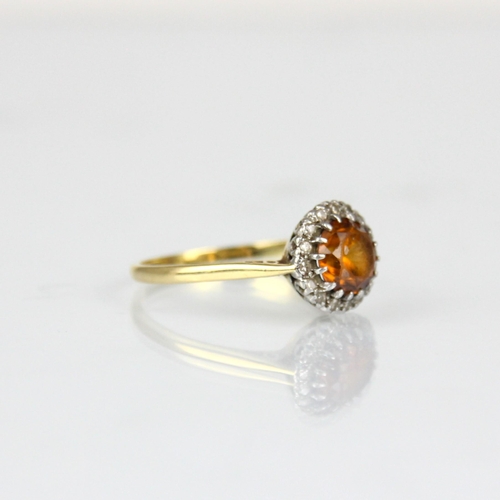 302 - A mid 20th century diamond cluster ring, the central round cut orange stone within surround of round... 