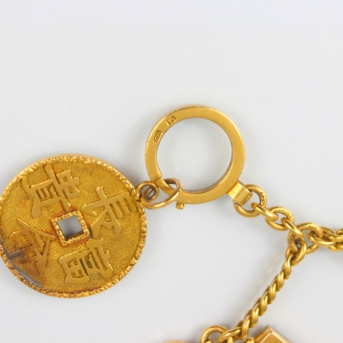 306 - A yellow metal Asian watch chain, the curb link chain suspending locket compass, stamped ‘k18’ and a... 